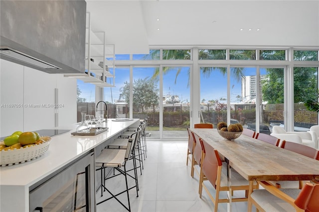 interior space with wine cooler, floor to ceiling windows, and a healthy amount of sunlight