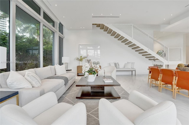 living room featuring a towering ceiling