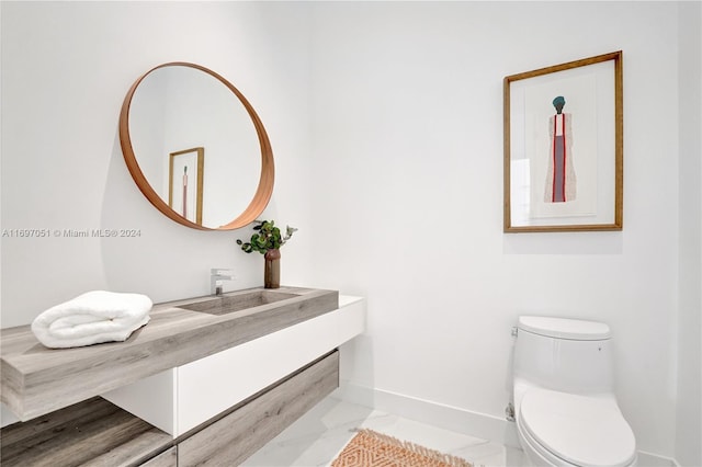 bathroom featuring vanity, toilet, and wood-type flooring