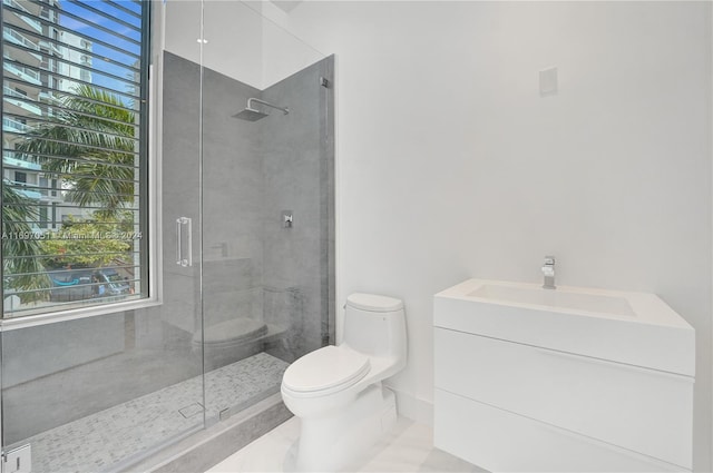 bathroom with tile patterned flooring, vanity, a shower with door, and toilet