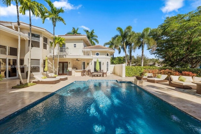 view of swimming pool with ceiling fan, a patio, and an outdoor living space