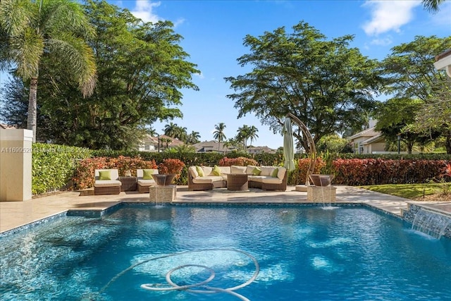 view of pool with pool water feature, an outdoor hangout area, and a patio area