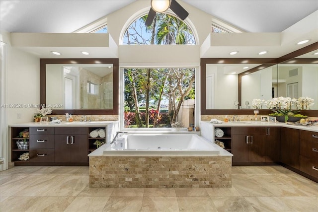 bathroom featuring vanity, a relaxing tiled tub, and ceiling fan