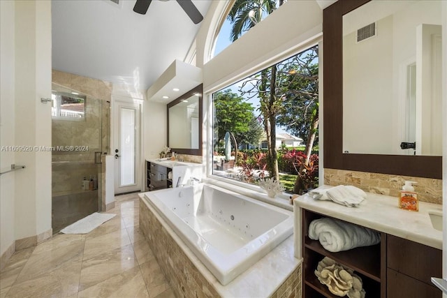 bathroom featuring ceiling fan, vanity, independent shower and bath, and vaulted ceiling