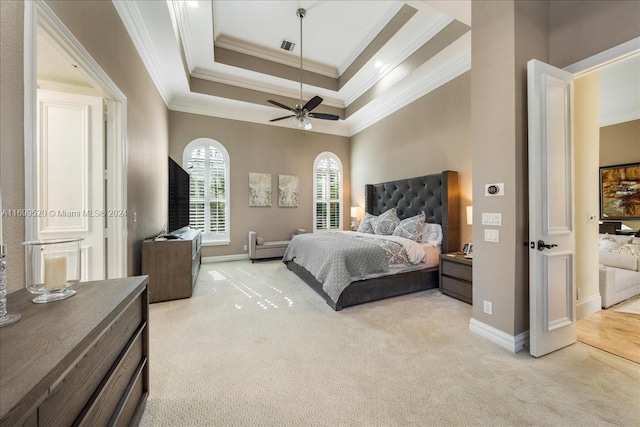 carpeted bedroom featuring a raised ceiling, ceiling fan, and ornamental molding