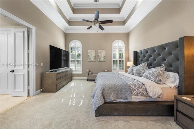 carpeted bedroom with a raised ceiling, ceiling fan, and crown molding