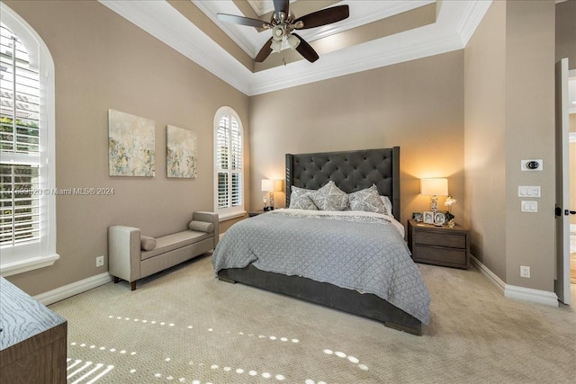 bedroom featuring light colored carpet, multiple windows, ornamental molding, and ceiling fan