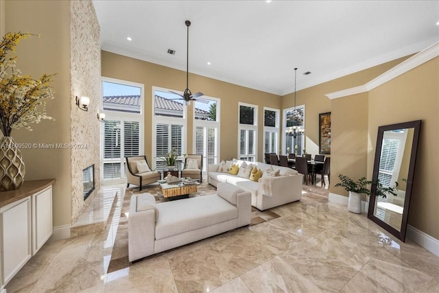 living room featuring ceiling fan and crown molding