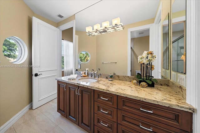 bathroom with tile patterned floors and vanity