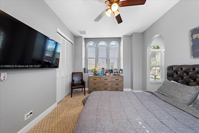 bedroom featuring ceiling fan and light colored carpet