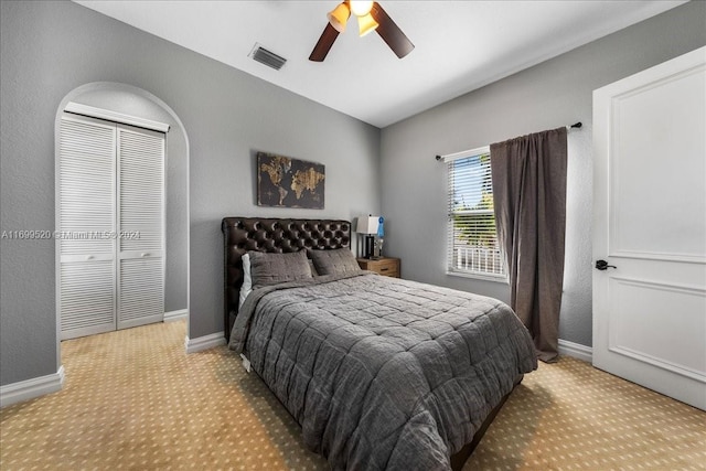 bedroom with ceiling fan and a closet