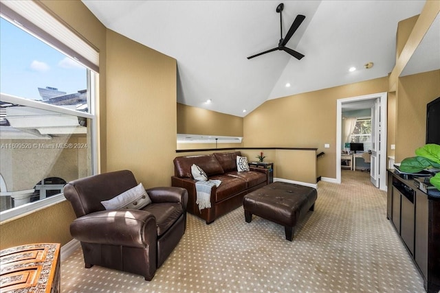 carpeted living room with ceiling fan and lofted ceiling