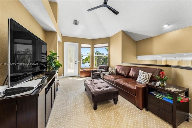 carpeted living room with ceiling fan and lofted ceiling