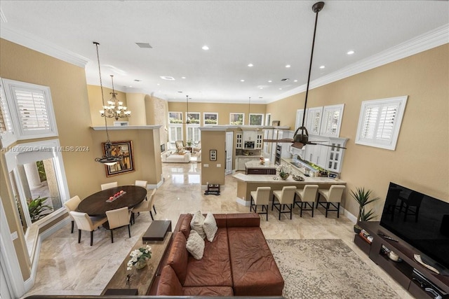 living room featuring an inviting chandelier and crown molding