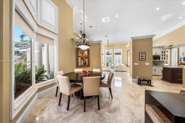 dining space with a wealth of natural light, crown molding, and an inviting chandelier