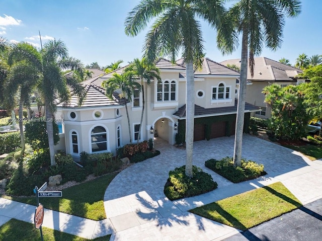 mediterranean / spanish-style home with a garage