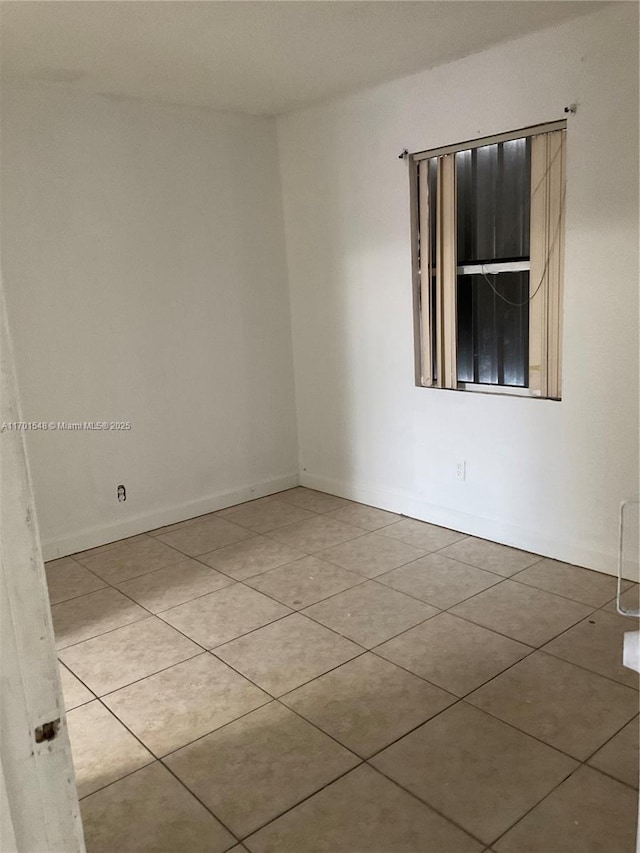 spare room featuring light tile patterned floors