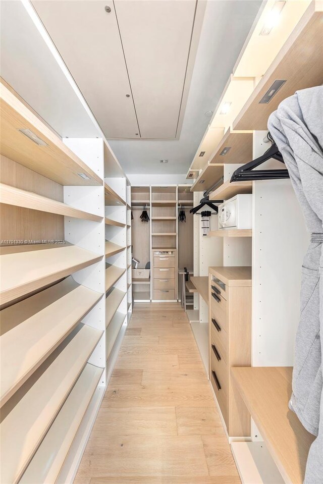 walk in closet featuring light hardwood / wood-style flooring