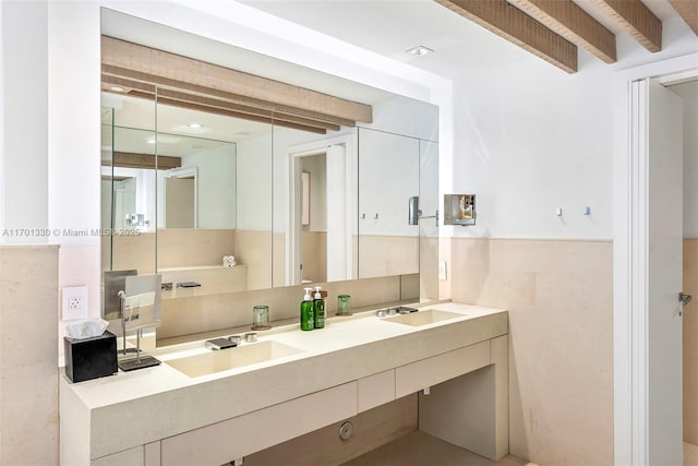 bathroom with vanity, tile walls, and beamed ceiling