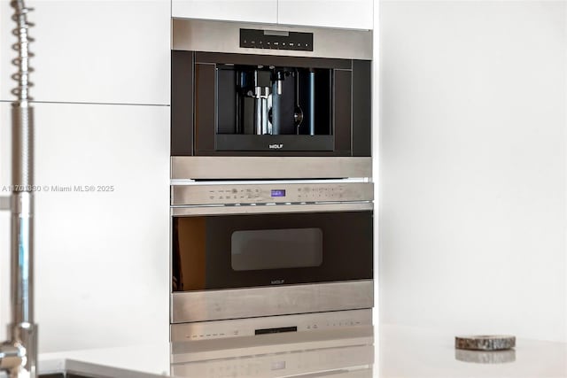 room details with double oven and white cabinets