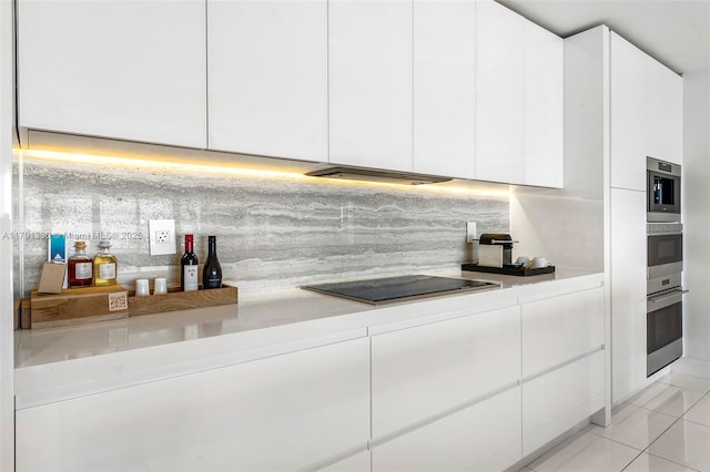 kitchen with tasteful backsplash, white cabinetry, black electric stovetop, and light tile patterned floors