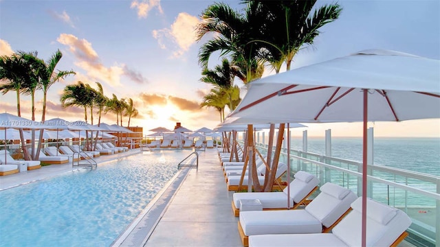 pool at dusk with a water view