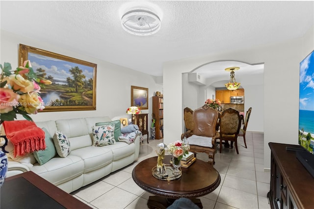 living room with light tile patterned floors and a textured ceiling