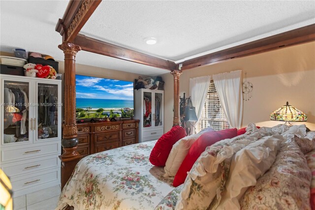 bedroom featuring light tile patterned floors and a textured ceiling