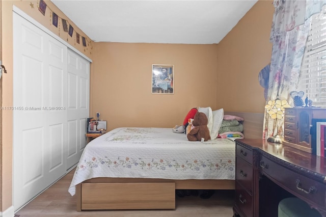 bedroom featuring light hardwood / wood-style flooring and a closet