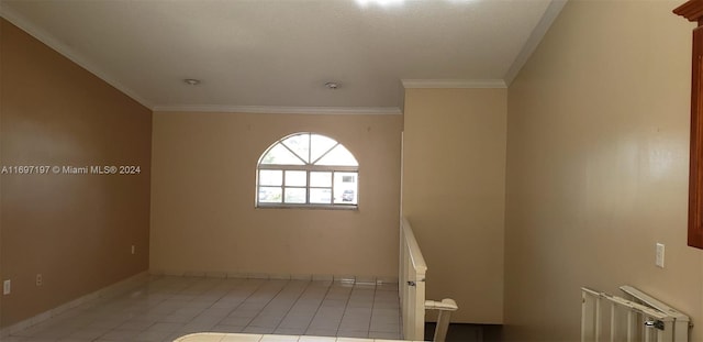 tiled empty room featuring ornamental molding and radiator