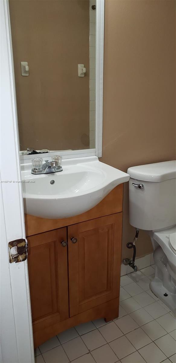 bathroom featuring tile patterned floors, vanity, and toilet