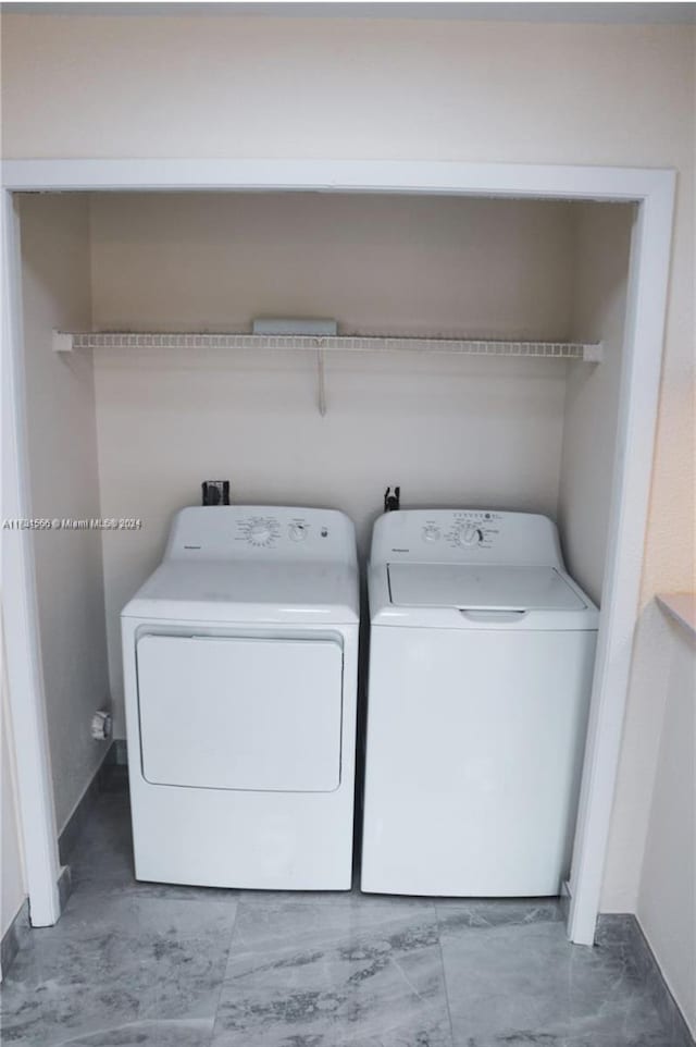 clothes washing area featuring independent washer and dryer