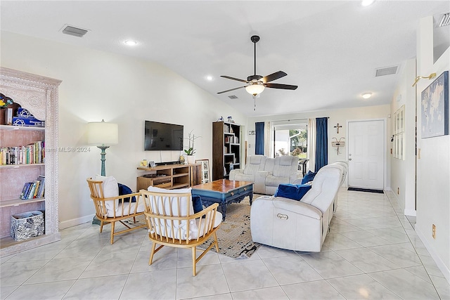 living room featuring ceiling fan, light tile patterned floors, and vaulted ceiling