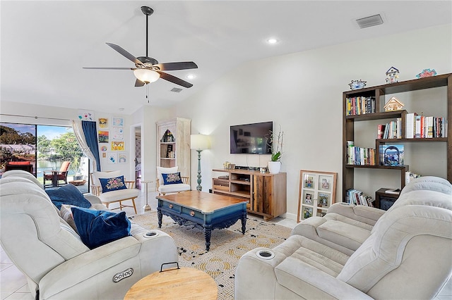 living room featuring ceiling fan, light tile patterned flooring, and lofted ceiling