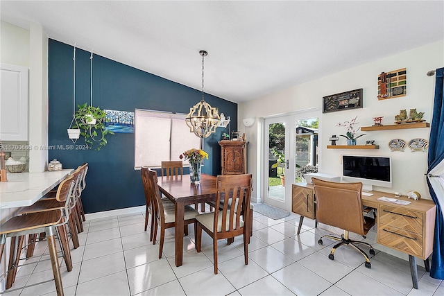 tiled dining room with french doors, an inviting chandelier, and vaulted ceiling