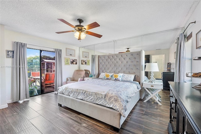 bedroom featuring ceiling fan, dark hardwood / wood-style flooring, a textured ceiling, and access to outside