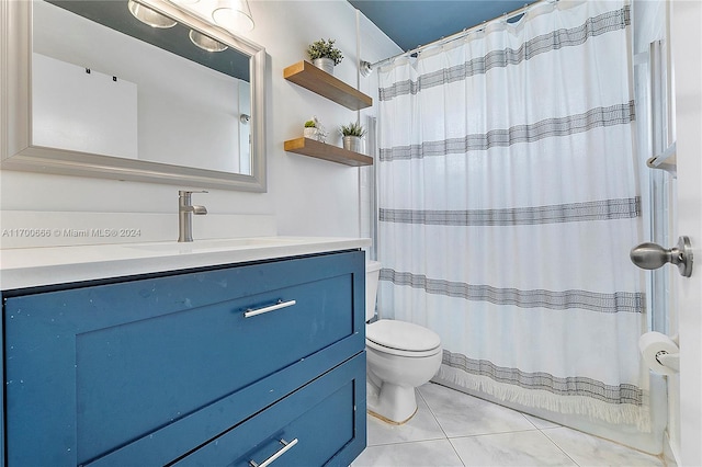 bathroom featuring tile patterned floors, vanity, and toilet