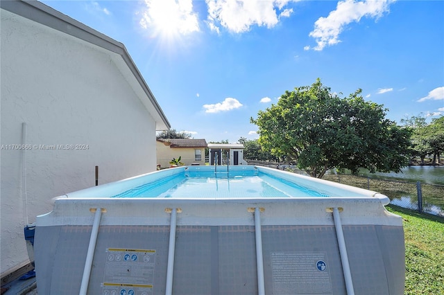 view of pool featuring a water view