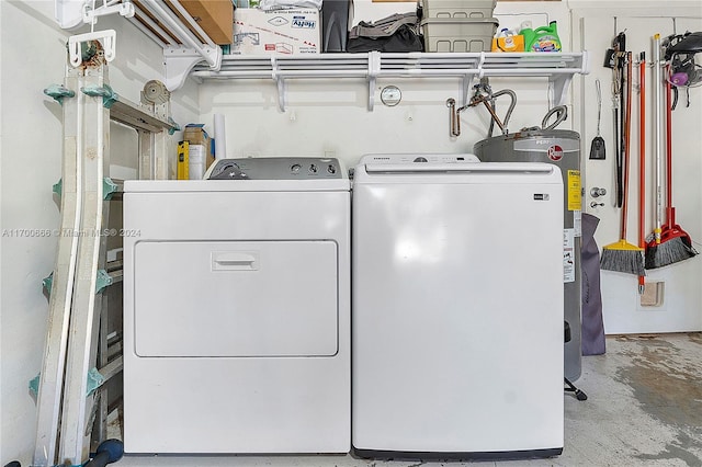 clothes washing area with electric water heater and separate washer and dryer