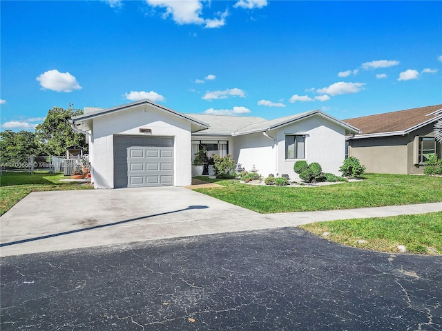 single story home with a garage and a front yard