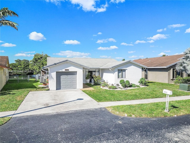 ranch-style house featuring a front lawn and a garage