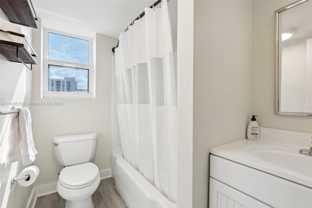 full bathroom with shower / bath combination with curtain, vanity, wood-type flooring, and toilet