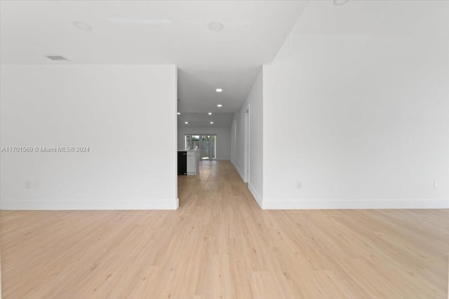 hallway with light hardwood / wood-style floors