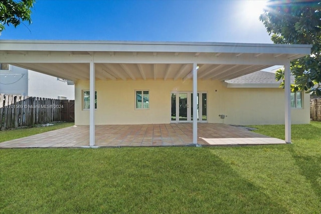 back of property featuring a yard and a patio