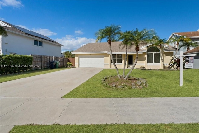 view of front of house featuring a garage and a front lawn