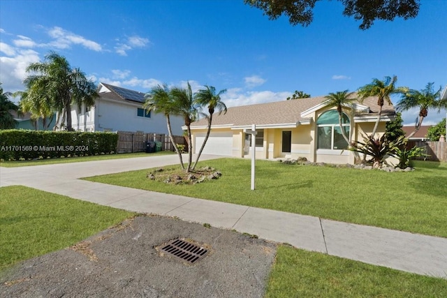 ranch-style house with a garage and a front yard