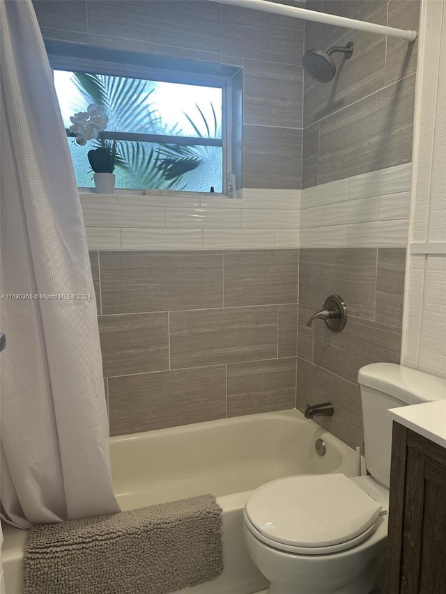 full bathroom featuring shower / tub combo with curtain, vanity, and toilet