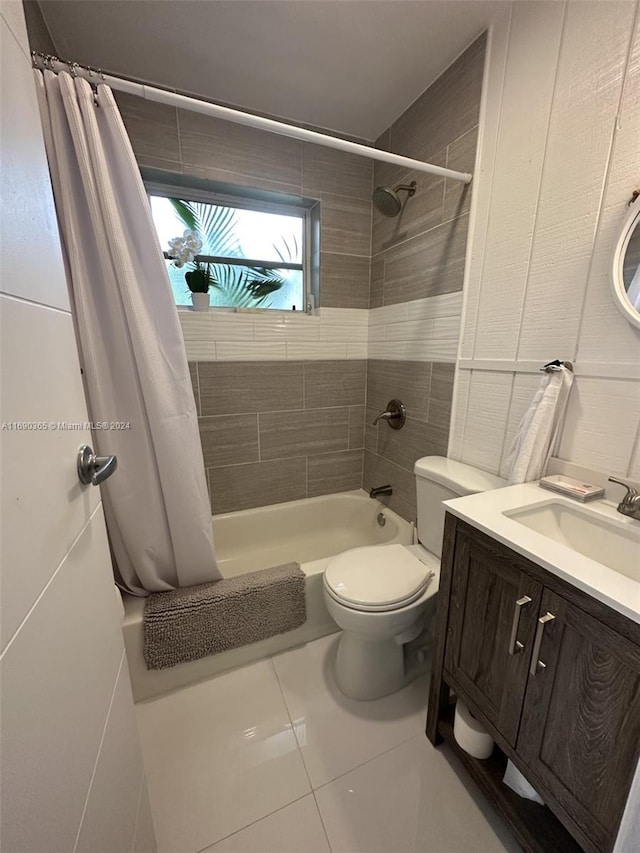 full bathroom featuring tile patterned floors, shower / bath combo with shower curtain, vanity, and toilet