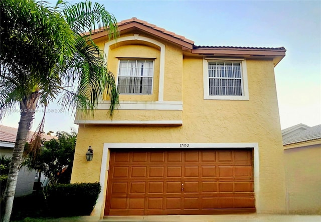 mediterranean / spanish-style house with a garage