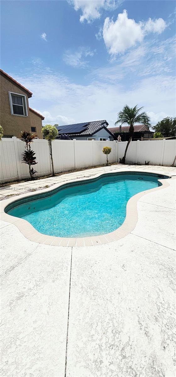 17352 SW 18th St, Miramar, FL 33029 - view of pool featuring a fenced backyard and a patio area